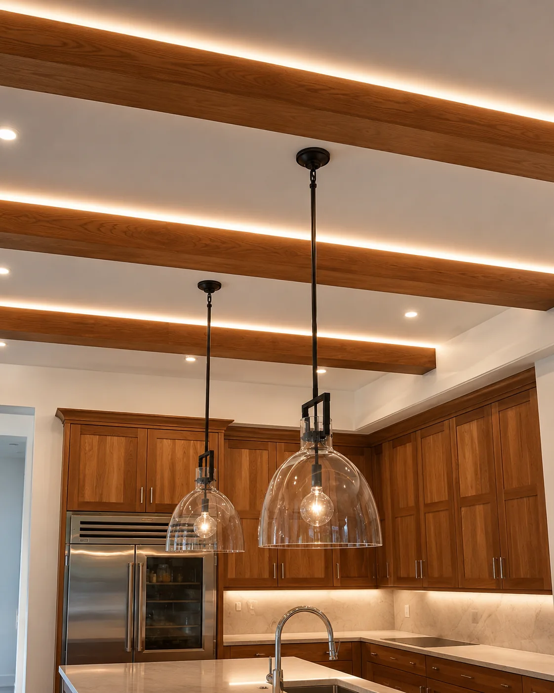 Custom kitchen with under-beam linear lighting, recessed downlights, and pendant fixtures