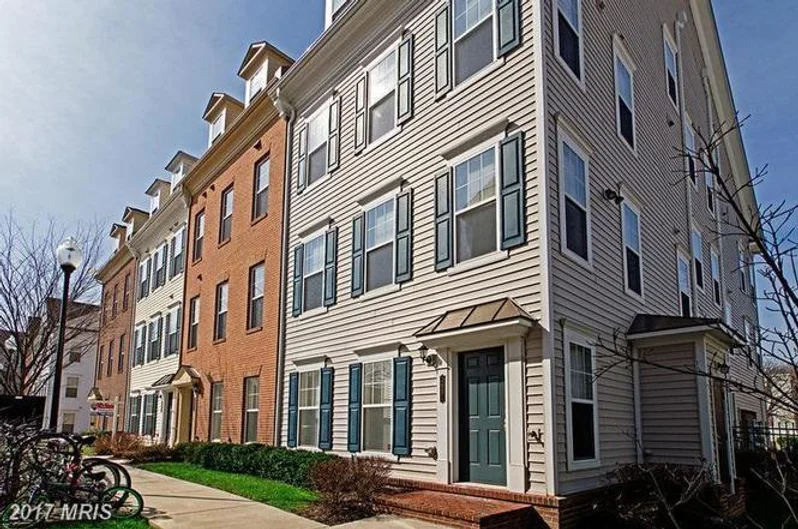 Multi-story townhomes with brick facade